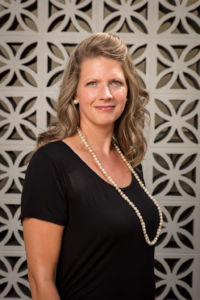 Lindsey Lupo wearing a black tip and long beaded necklace headshot for Gold Coast Doulas