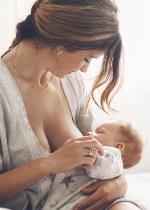 Breastfeeding mother nurses her infant
