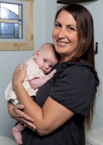 Julie from Gold Coast Doulas holding an infant in a bathroom