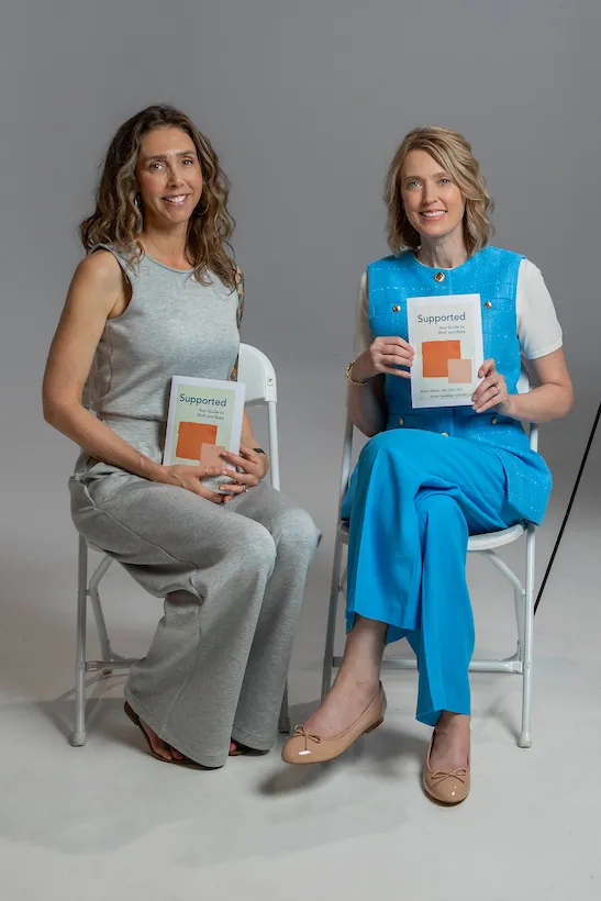 Alyssa Veneklese and Kristin Revere sitting holding copies of their book Supported