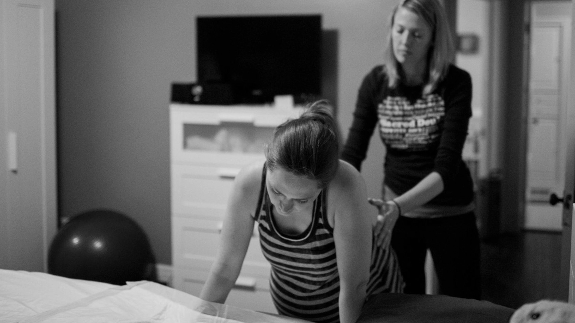 Doula Kristin Revere helping a mother with contractions while she prepares to give birth